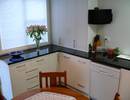 Granite top with on-bench pantry with bi-fold doors